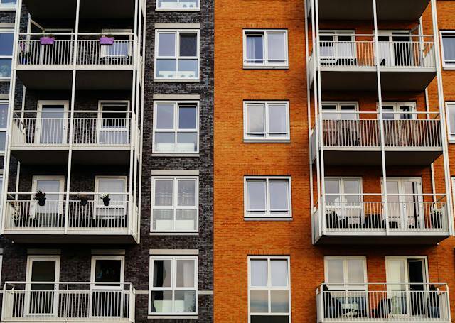 a black an orange apartment building with balconies